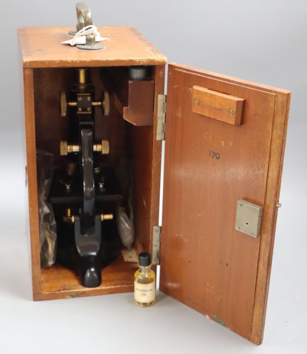 An Edinburgh University black lacquered microscope, cased